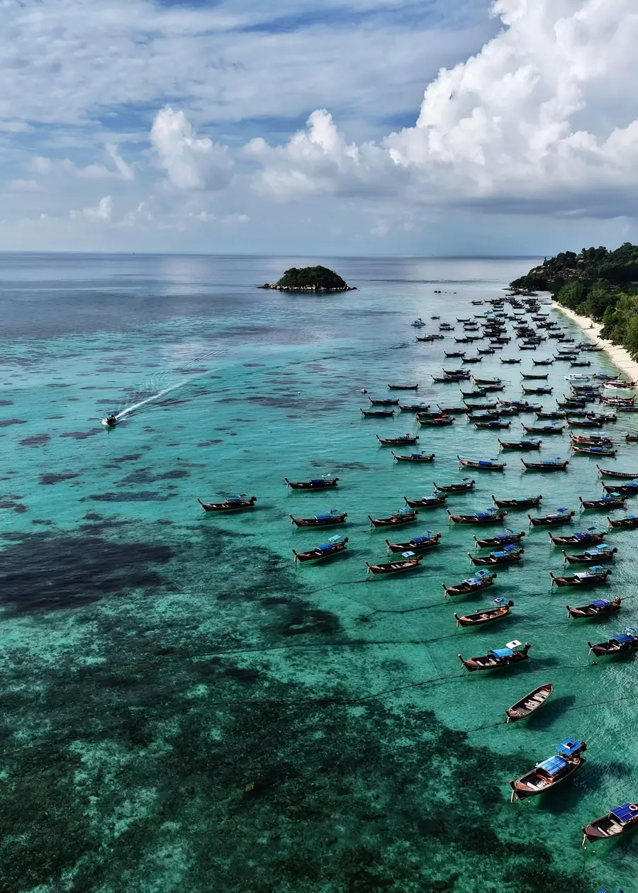 Sunrise Beach from above with longtails on the water