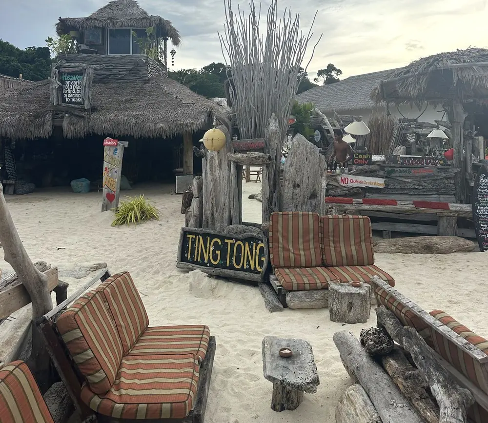 Zodiac beach bar: driftwood, striped cushions, the Ting Tong sign